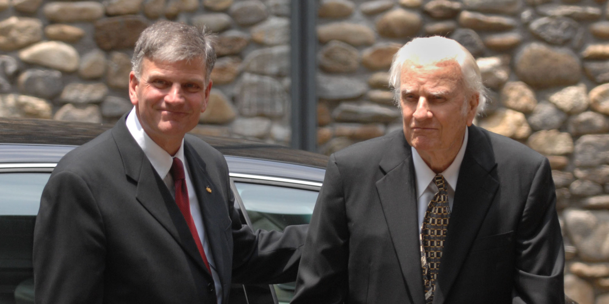 Franklin Graham, left, escorts his father Billy Graham prior