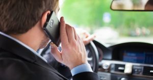 Man talking on the phone on his car